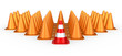A group of orange traffic cones with a red one in front