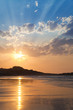 Nice sunset with lots of sunbeams at a lonely beach
