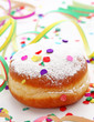 Krapfen or donut with jam and icing sugar