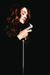 Beautiful singer singing with microphone
