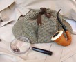 A Tweed Hat, Pipe, and Magnifying Glass