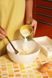 Woman preparing dough for pancakes