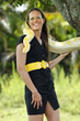 Young woman plays with a albino burmese python