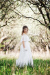 beautiful woman in white dress walking in park