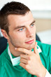 Self-assured male surgeon wearing scrups looking to the side
