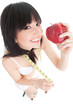 Fun woman with red apple and measure tape on the glass scales