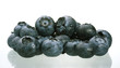Bilberries on white background with reflection.