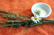 Small bowl with flowers on orange towel