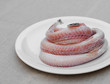 Fresh raw sea eel (conger) on white plate Fresh raw sea eel (conger) on white plate