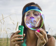 Foto: face of woman that blows soap bubbles face of woman that blows soap bubbles