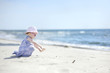 Adorable toddler girl on a sand beach