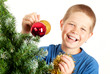 Young boy holding Christmas decorations and smiling