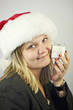 beautiful business woman in santa hat with gift