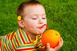 The child is drinking orange juice