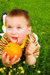 The child is drinking orange juice