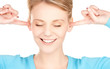 smiling woman with hands over ears