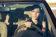 Beautiful happy woman driving her car in the evening