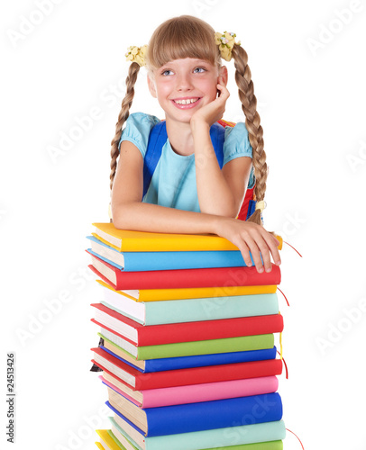 Photo: Schoolgirl with backpack holding pile of books. Schoolgirl with backpack holding pile of books.