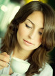 Beautiful Young Woman drinking Coffee
