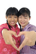 Mother with daughter. Couple's hands making heart shape