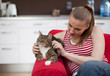 sitting on red sofa young woman with cat