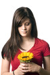 Young woman holding sunflower