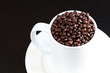 Coffee mug filled with fresh coffee beans Coffee mug filled with fresh coffee beans
