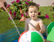 Toddler playing with water in the hot day
