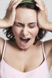 Photo: young woman screaming from pain and holding her head young woman screaming from pain and holding her head