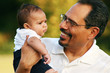 Older man holding and smiling at baby Older man holding and smiling at baby