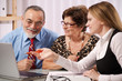 Senior couple meeting with agent or advisor