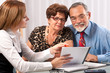 Senior couple meeting with agent or advisor Senior couple meeting with agent or advisor