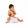 Baby toddler stuffing his mouth with birthday cake