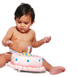 Baby eating cake by himself