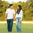 Photo: Young couple talking and walking Young couple talking and walking