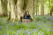 A young woman sitting under a tree, relaxing