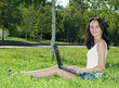 Portrait of  beautiful woman in a park with laptop