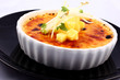 Delicious french dessert creme brulee in porcelain bowl
