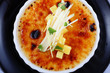Delicious french dessert creme brulee in porcelain bowl