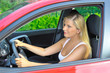 beautiful woman driver in red shiny car outdoors smiling