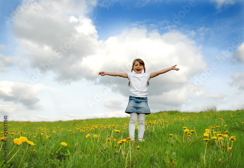 Photo: Little girl playing on meadow Little girl playing on meadow