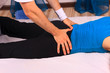 Young woman gets lower back massage Young woman gets lower back massage