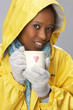 Young Woman Drinking Hot Drink Wearing Yellow Raincaot