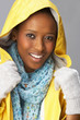 Young Woman Wearing Yellow Raincoat In Studio