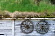 Foto: Alte Holzräder an einer Hütte aus Holz mit Gras Dach Alte Holzräder an einer Hütte aus Holz mit Gras Dach