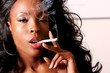 Beautiful african american woman smoking cigarette