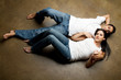 Sexy youngethnic casual couple relaxing on the floor