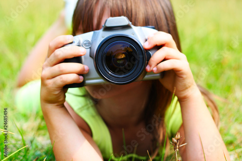 Photo: The child holds the photocamera The child holds the photocamera