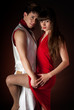 Young couple dancing embrace passion romance on dark red light