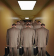 Foto: Overworked Business Men Walking down Hallway Overworked Business Men Walking down Hallway